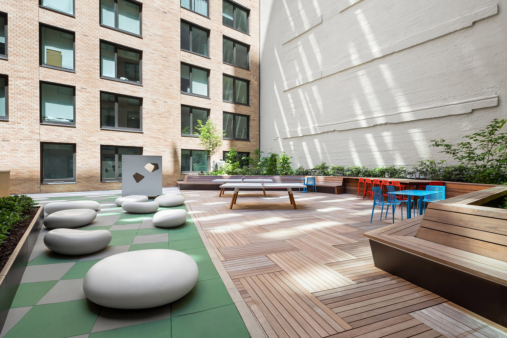 Pierrepont Courtyard featuring ample seating, ping pong tables and a play-space for children
